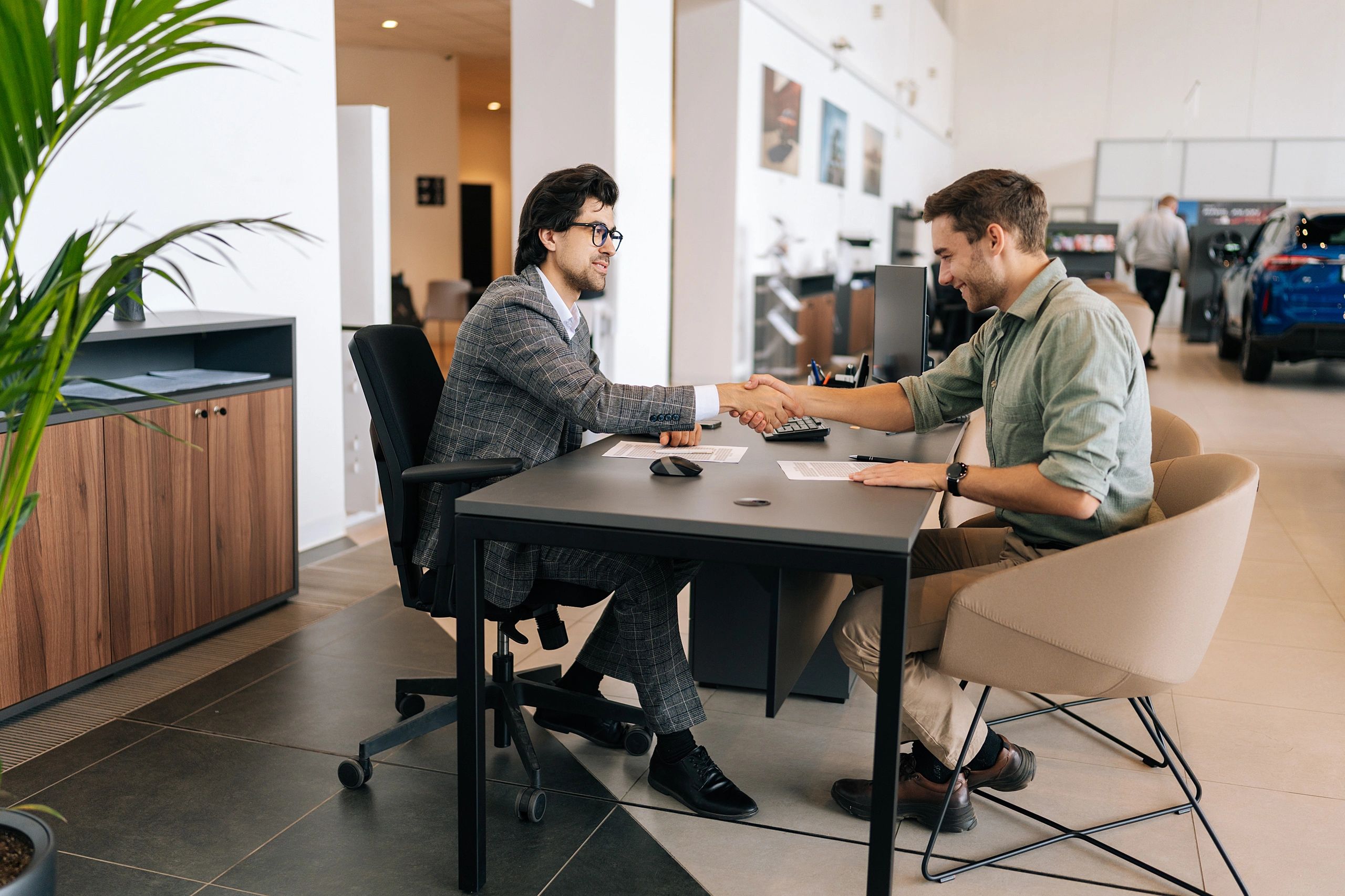 Customer reviewing car financing paperwork at a dealership