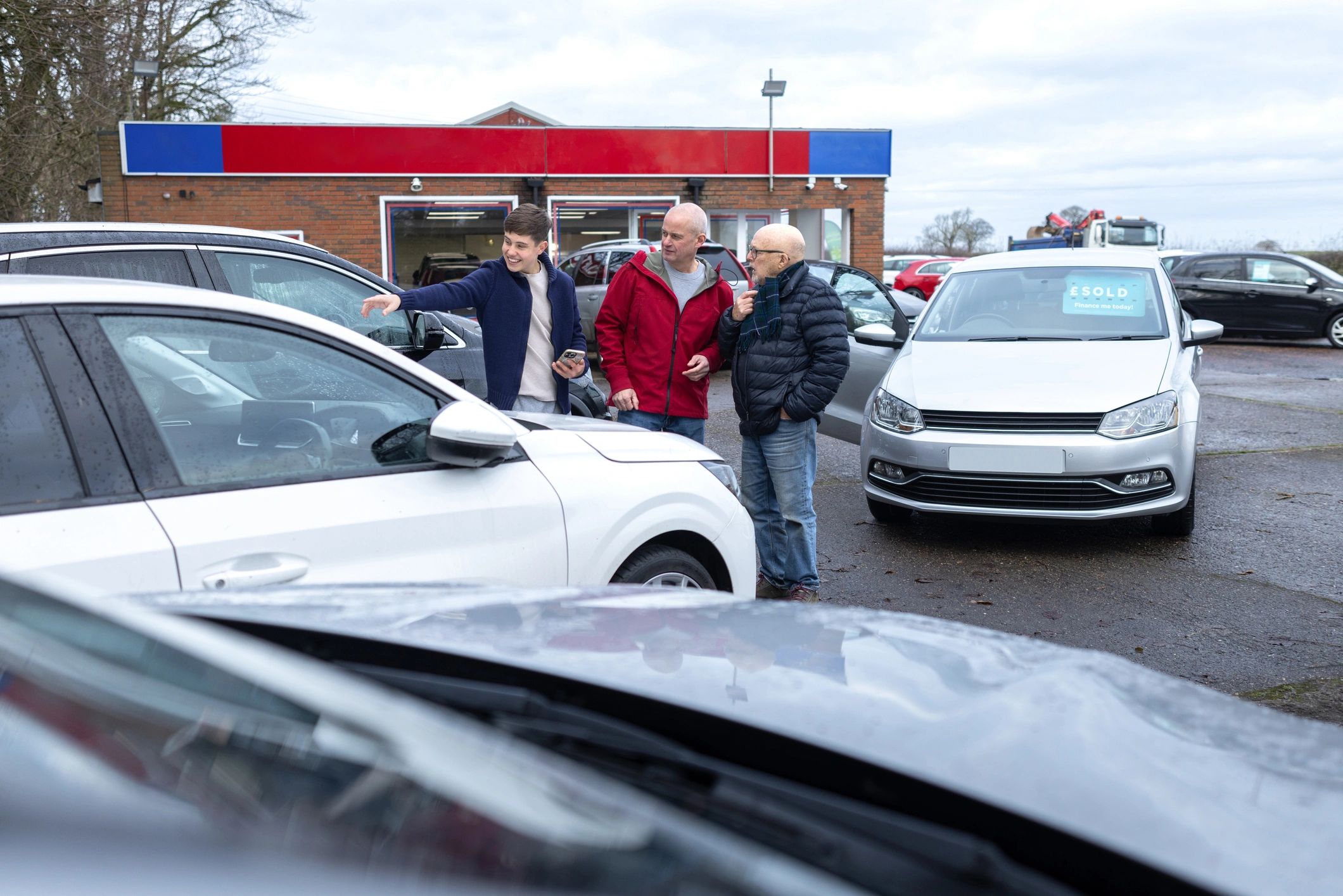Car shoppers discussing financing options at a dealership
