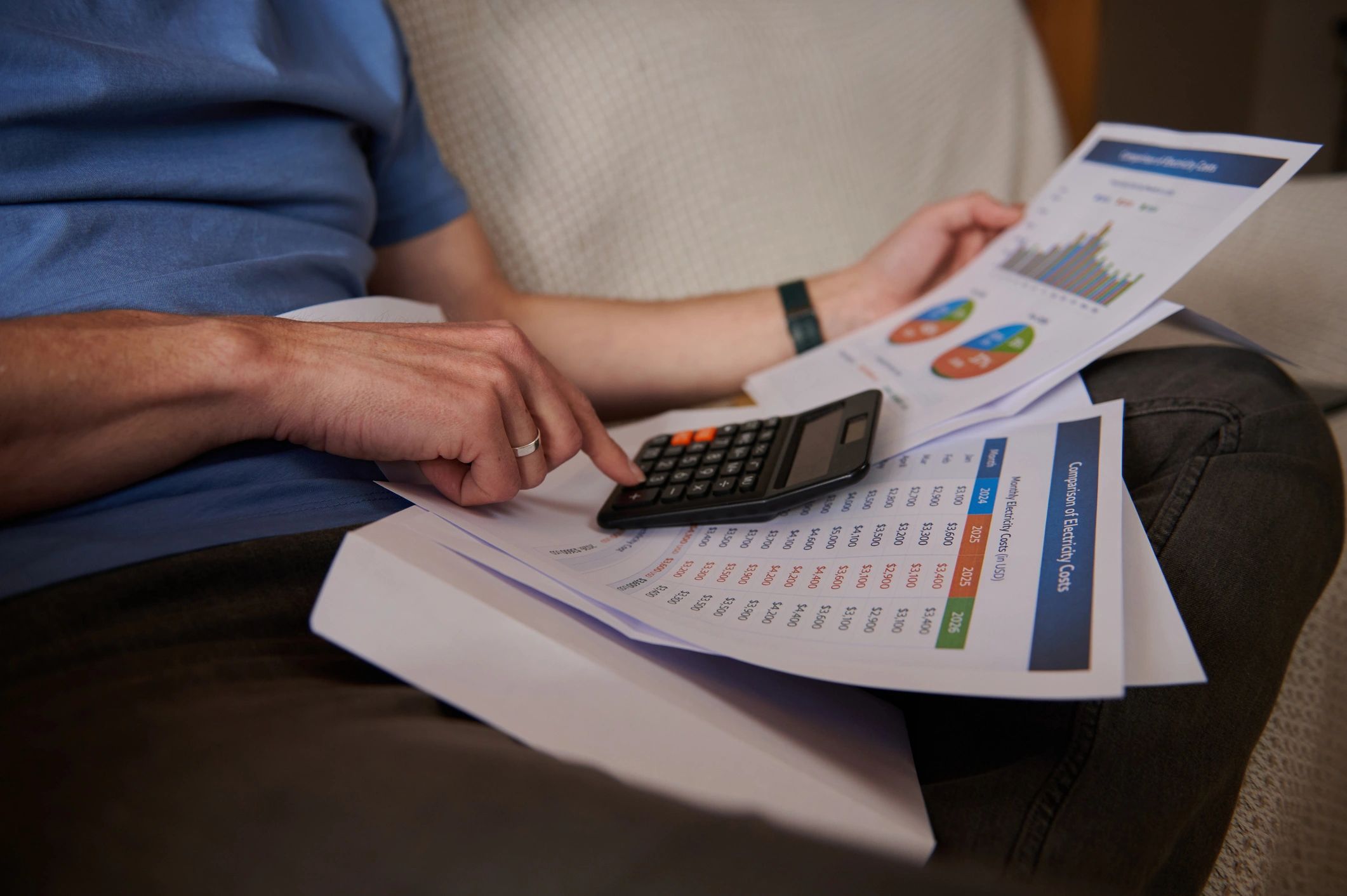 Person using calculator with financial documents